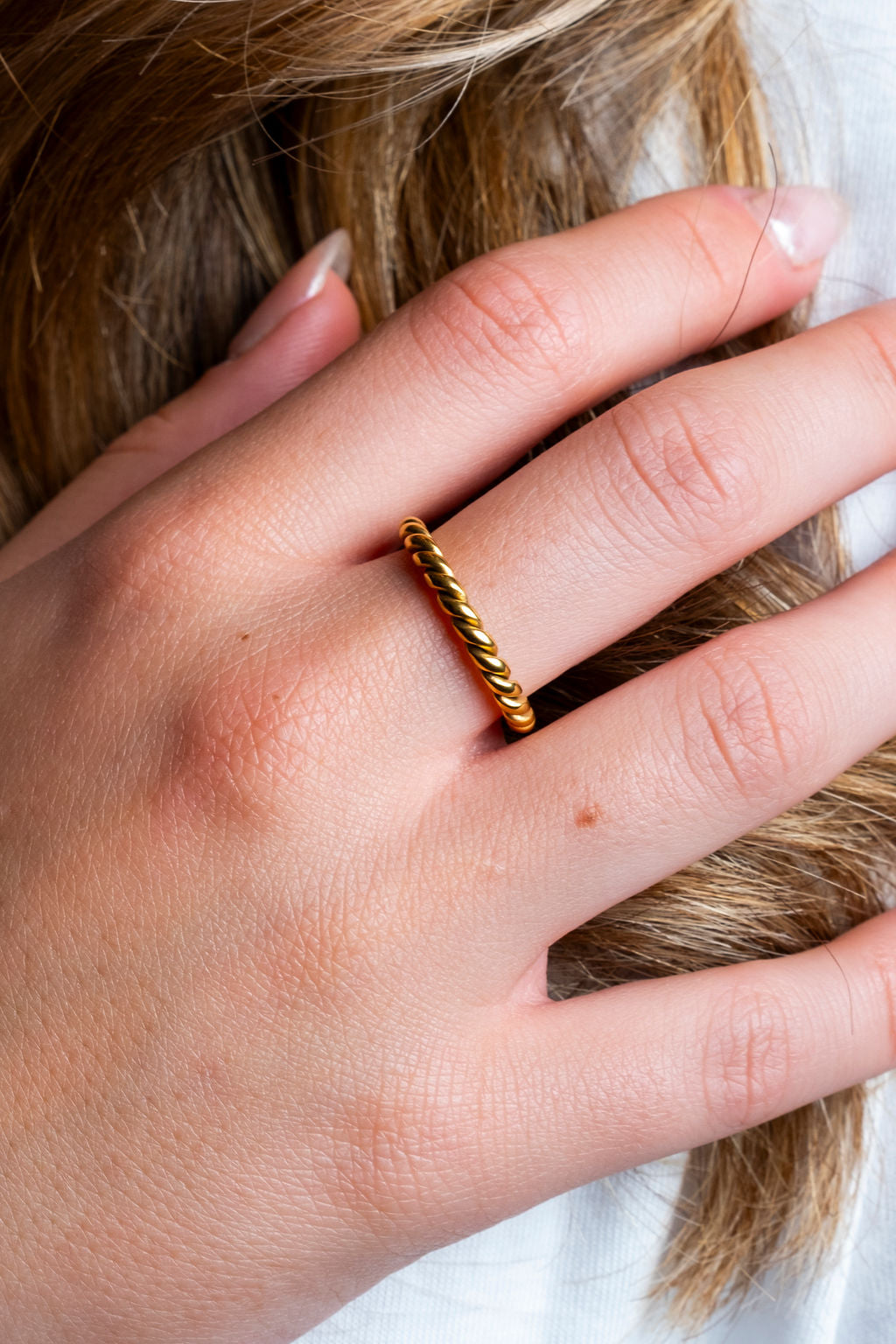 Gold twist ring, sweatproof and tarnish-free, perfect for active individuals, worn by model